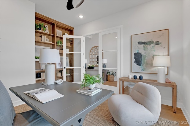 office area with ceiling fan and light hardwood / wood-style floors