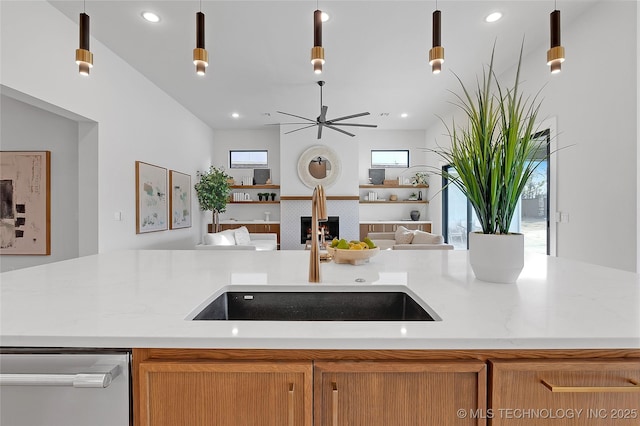 kitchen featuring pendant lighting, dishwasher, and sink