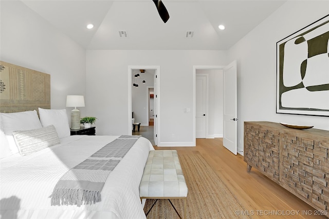 bedroom featuring lofted ceiling, hardwood / wood-style floors, and ceiling fan