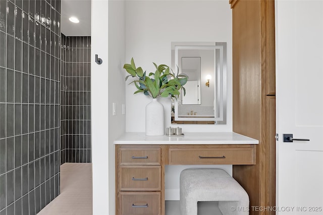 bathroom featuring vanity and a tile shower