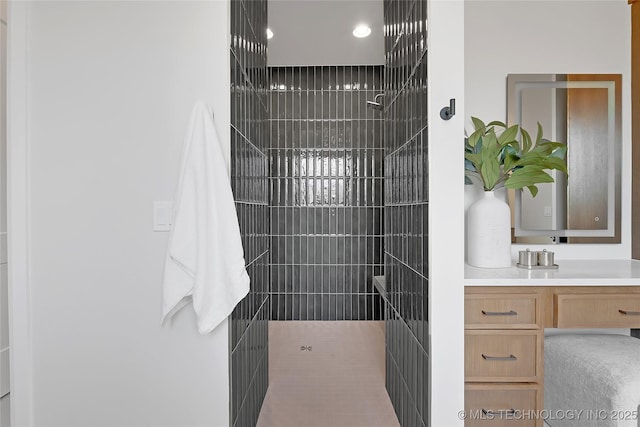 bathroom with vanity and tiled shower