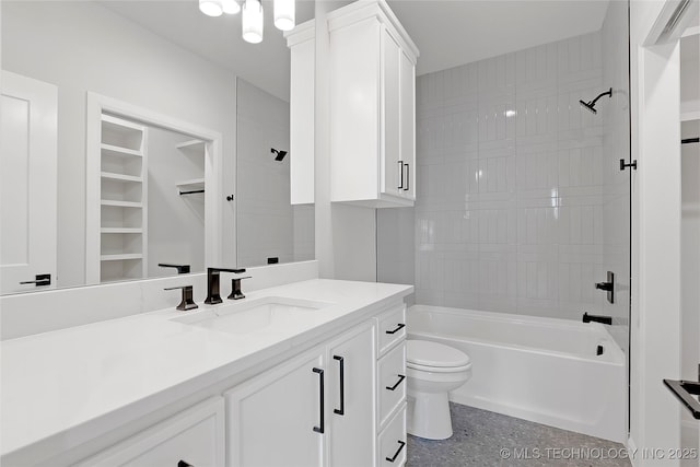 full bathroom featuring vanity, tiled shower / bath combo, and toilet