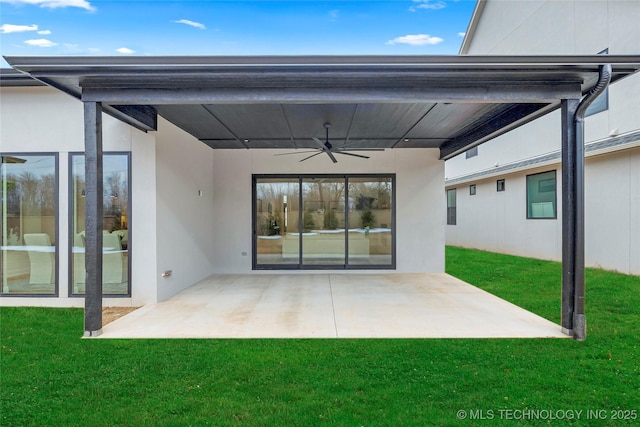 back of house featuring a yard, a patio area, and ceiling fan