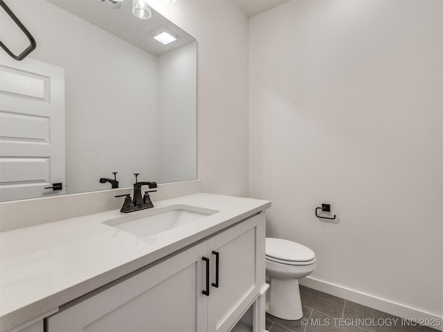 bathroom featuring toilet, tile patterned flooring, vanity, and baseboards