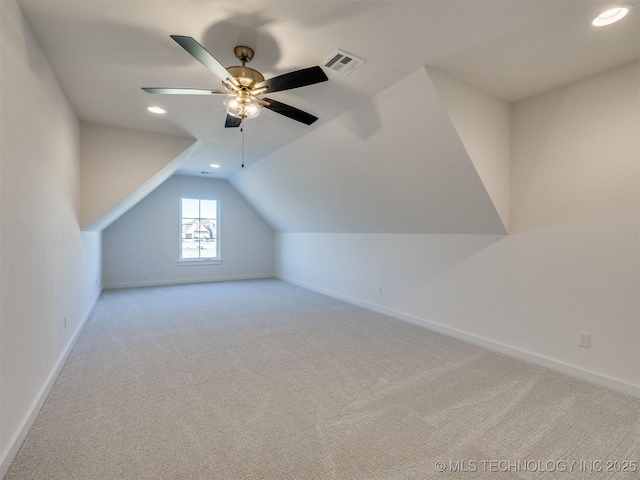 additional living space featuring light carpet, vaulted ceiling, and ceiling fan