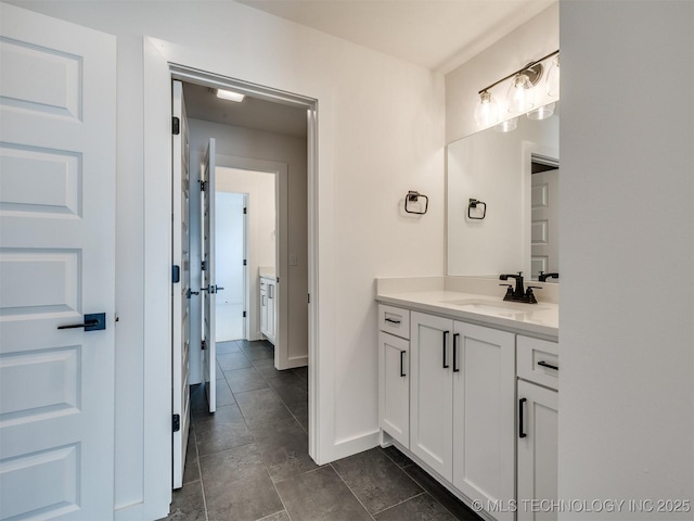 bathroom with vanity and baseboards