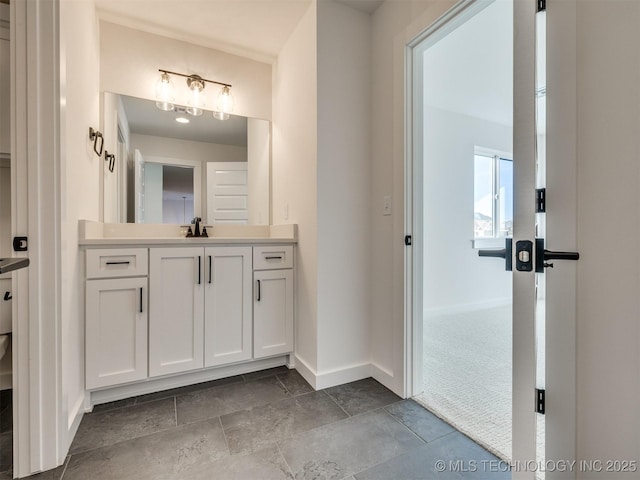 bathroom featuring baseboards and vanity