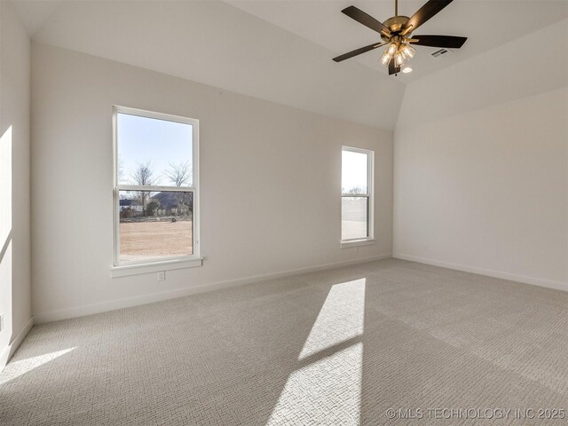 carpeted empty room with ceiling fan and vaulted ceiling