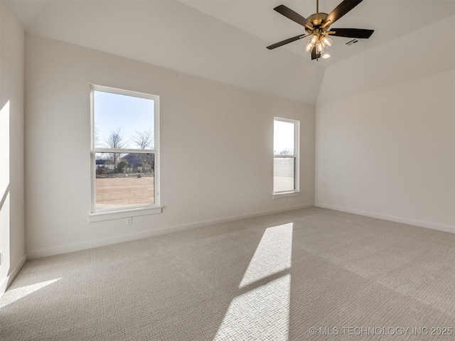 unfurnished room with ceiling fan, lofted ceiling, light colored carpet, visible vents, and baseboards