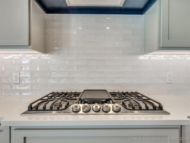 room details with stainless steel gas stovetop, light countertops, and decorative backsplash