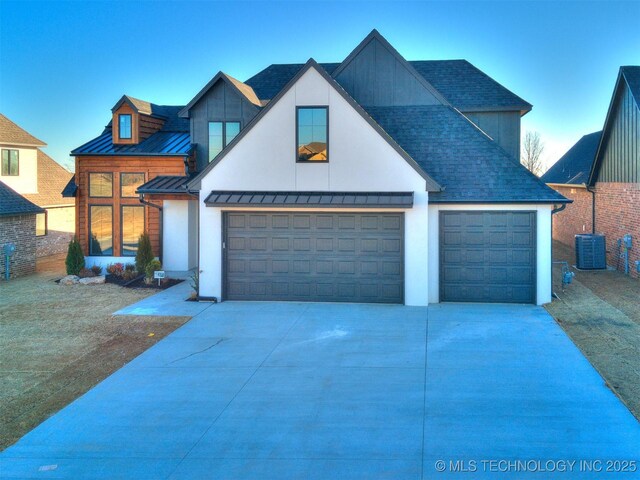 view of front of home with a garage and central AC unit