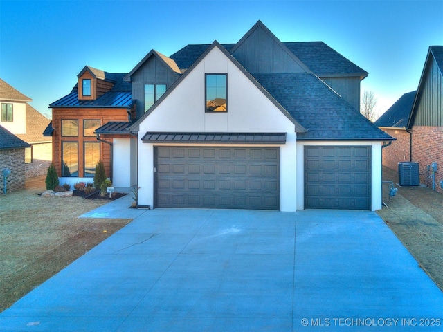 view of front facade featuring a standing seam roof, metal roof, concrete driveway, and roof with shingles