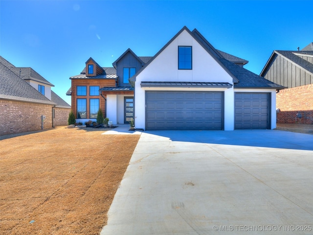 view of front of property with a shingled roof, a standing seam roof, metal roof, a garage, and driveway