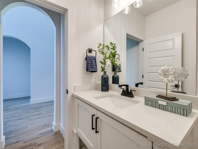 2508 E 135th Dr S, Bixby, OK 74008 - bathroom with wood finished floors, vanity, and baseboards