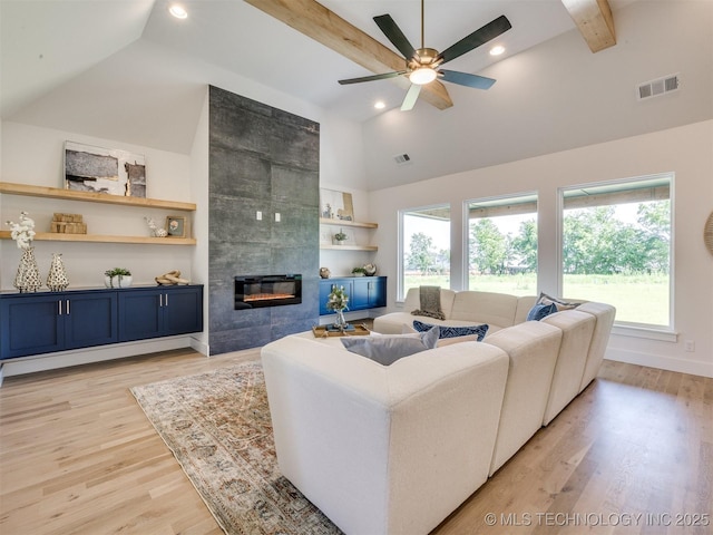 2508 E 135th Dr S, Bixby, OK 74008 - living area with a ceiling fan, high vaulted ceiling, recessed lighting, a tiled fireplace, and light wood-type flooring