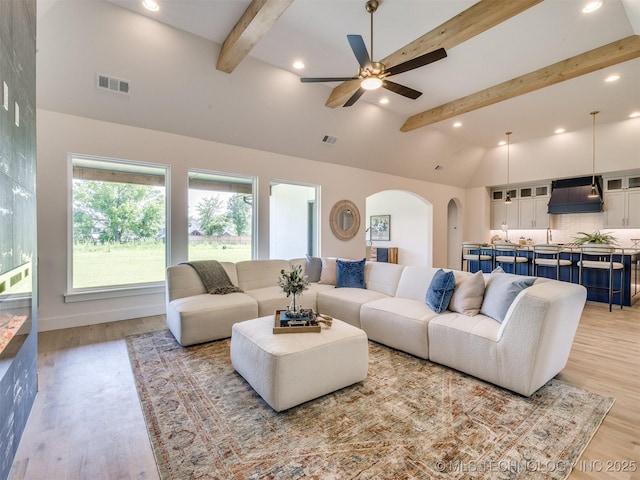 2508 E 135th Dr S, Bixby, OK 74008 - living room with arched walkways, recessed lighting, a ceiling fan, and light wood-style floors