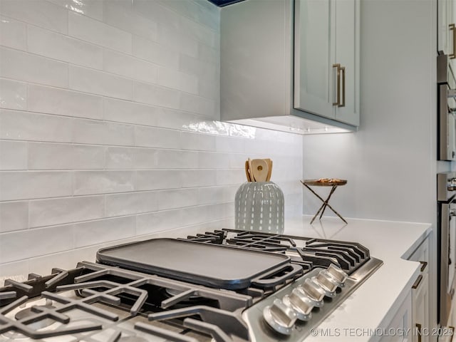 2508 E 135th Dr S, Bixby, OK 74008 - kitchen view of decorative backsplash, stainless steel gas stovetop, and light countertops