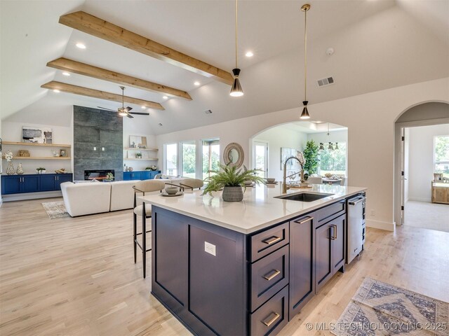 2508 E 135th Dr S, Bixby, OK 74008 - kitchen featuring a sink, arched walkways, a fireplace, a ceiling fan, and recessed lighting