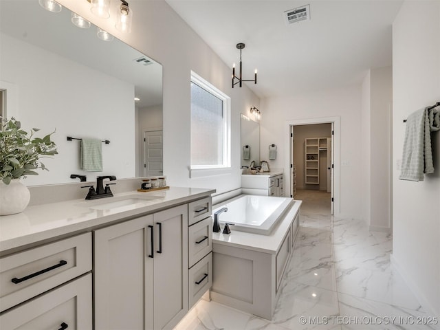 2508 E 135th Dr S, Bixby, OK 74008 - full bath featuring marble finish floors, two vanities, a chandelier, and a garden tub
