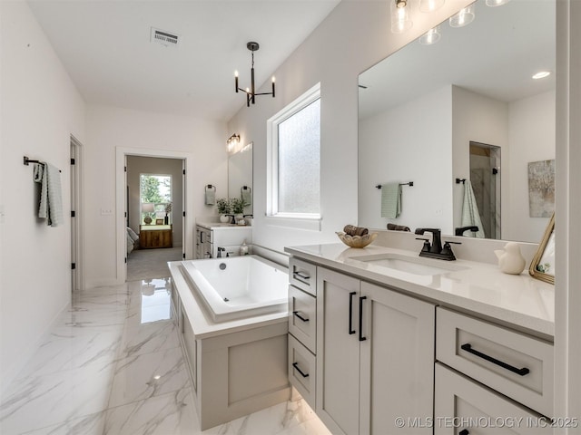 2508 E 135th Dr S, Bixby, OK 74008 - full bath featuring marble tiled floors, ensuite bath, a chandelier, a garden tub, and a shower stall