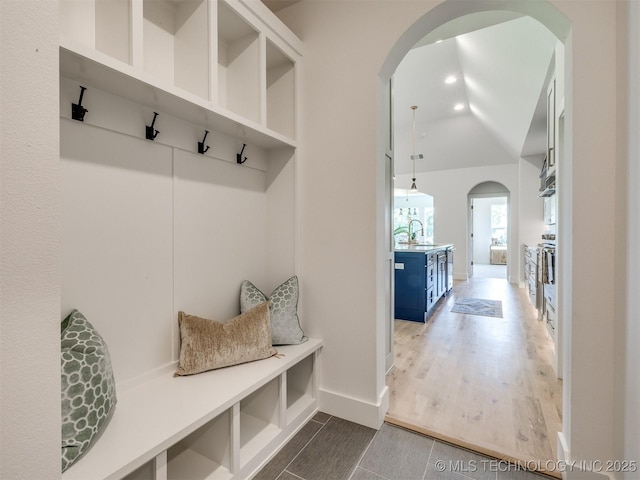 2508 E 135th Dr S, Bixby, OK 74008 - mudroom with arched walkways, a sink, baseboards, and wood finished floors