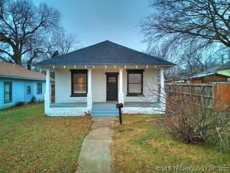 bungalow featuring a front yard and a porch