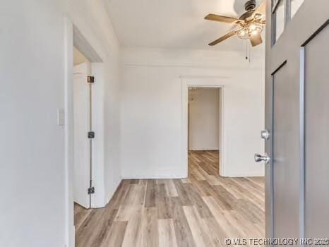 spare room featuring light hardwood / wood-style floors and ceiling fan