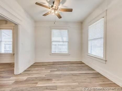 empty room featuring ceiling fan and light wood-type flooring