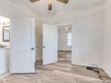 spare room featuring ceiling fan and light wood-type flooring