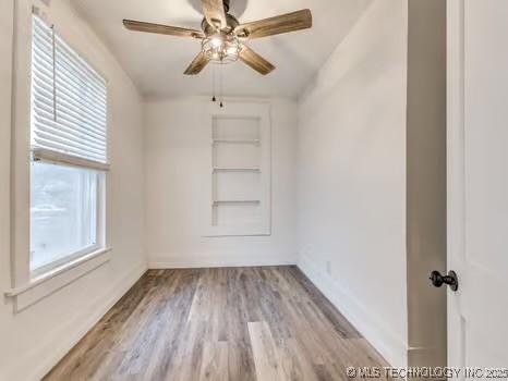 empty room featuring ceiling fan and light wood-type flooring