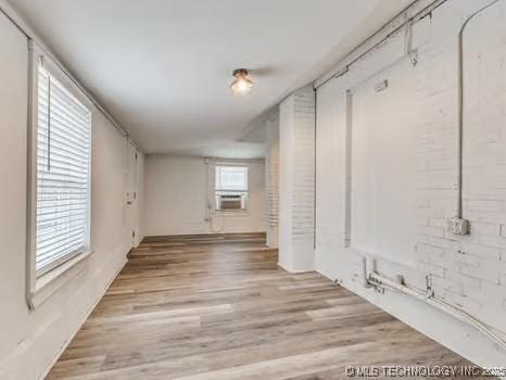 spare room with cooling unit and light hardwood / wood-style floors