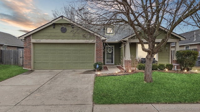 view of front of home with a yard and a garage