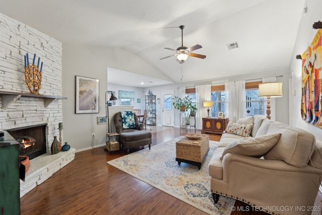 living room with dark hardwood / wood-style floors, ceiling fan, lofted ceiling, and a fireplace