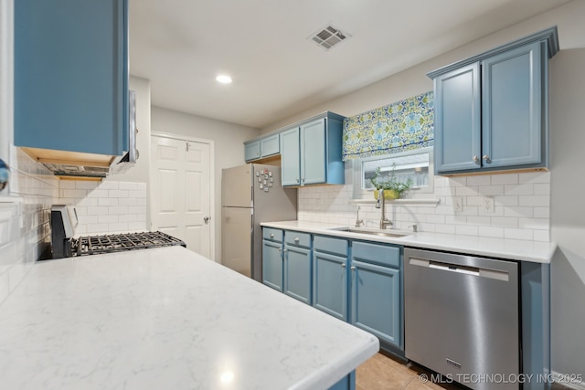 kitchen featuring sink, fridge, dishwasher, and blue cabinetry