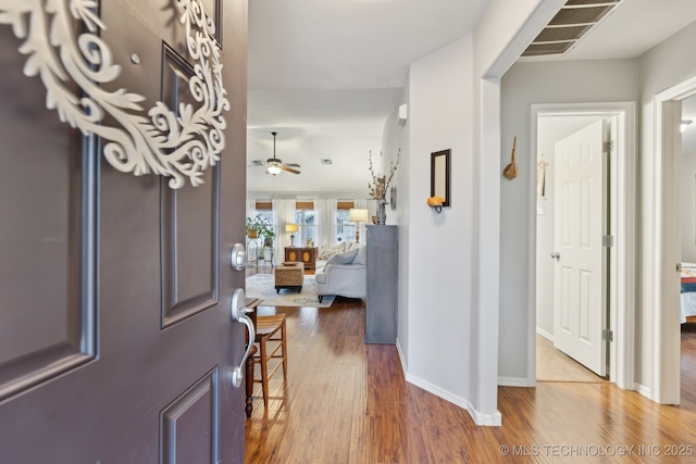 foyer featuring wood-type flooring and ceiling fan