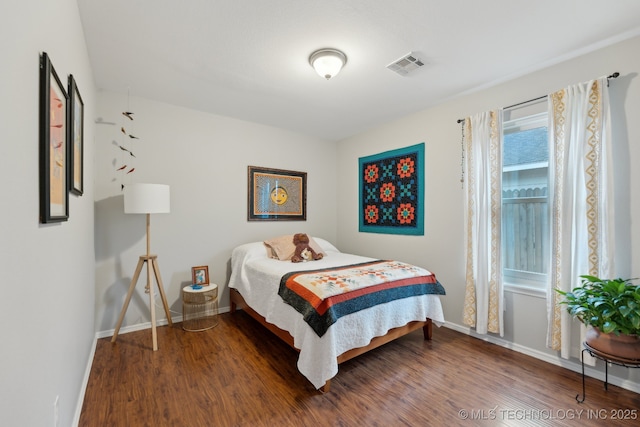 bedroom with hardwood / wood-style flooring