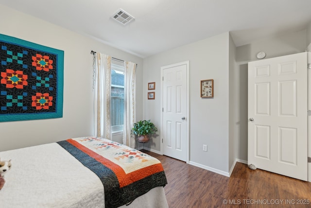 bedroom with dark hardwood / wood-style flooring