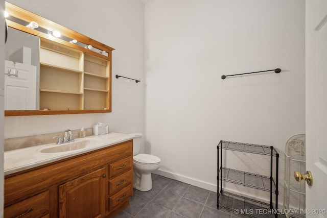 bathroom with vanity, tile patterned floors, and toilet