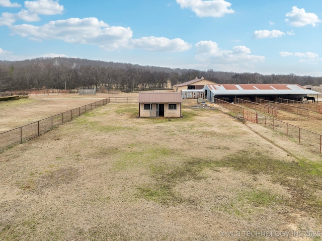 view of yard featuring an outbuilding and a rural view