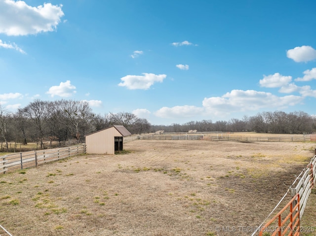 view of yard featuring a rural view and an outdoor structure