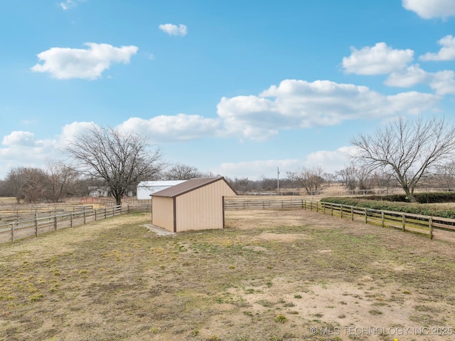 view of yard with an outbuilding and a rural view