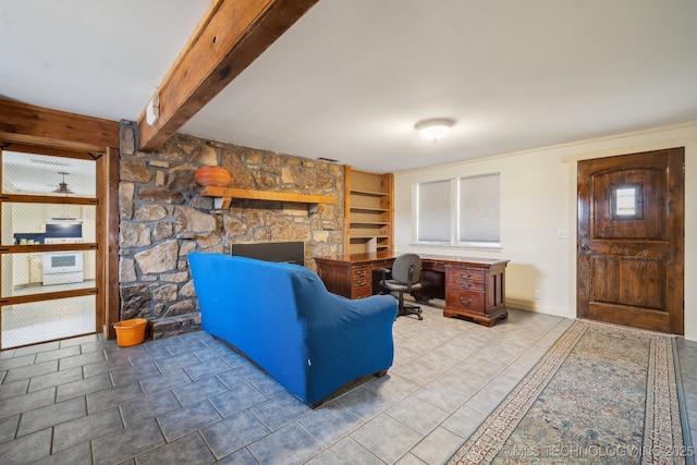 tiled living room featuring a stone fireplace, built in features, and beamed ceiling