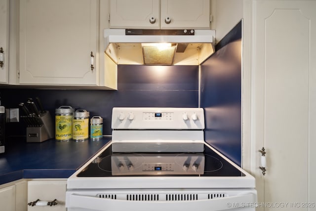 kitchen with white electric range and white cabinets