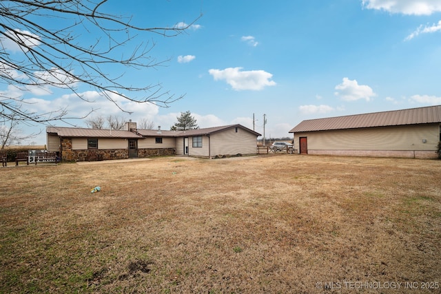 back of house with a yard