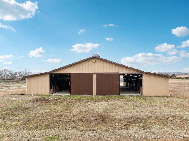 back of house with an outbuilding and a lawn