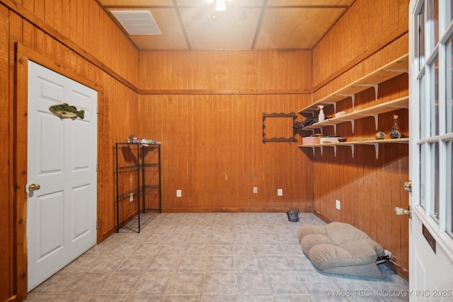 foyer with wooden walls