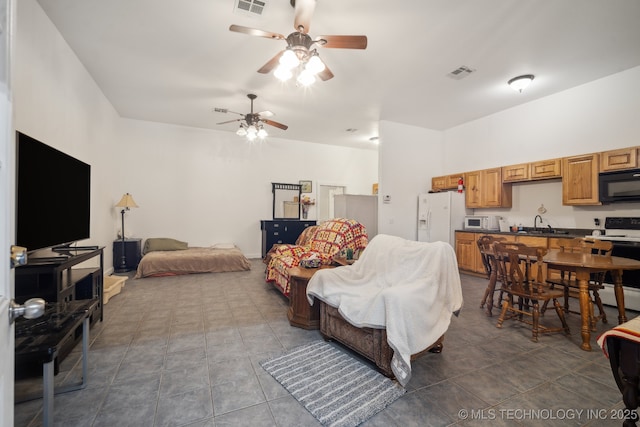 living room featuring dark tile patterned flooring, sink, and ceiling fan