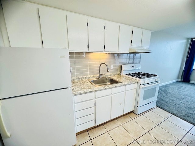 kitchen featuring sink, white appliances, white cabinetry, tasteful backsplash, and light carpet