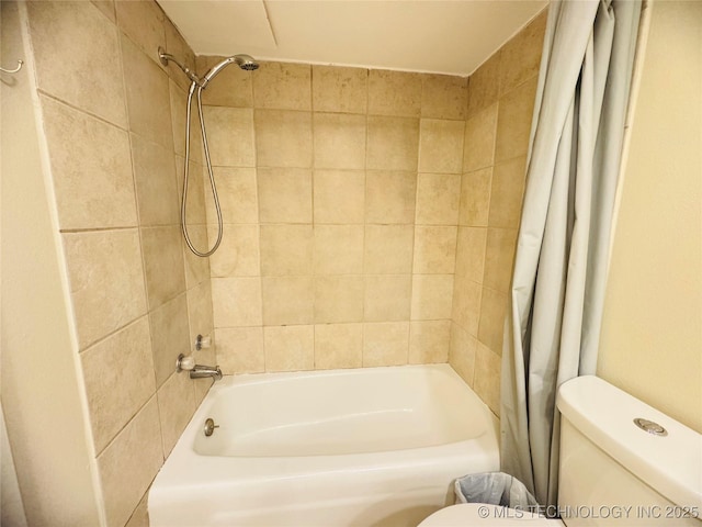 bathroom featuring shower / bath combo and toilet