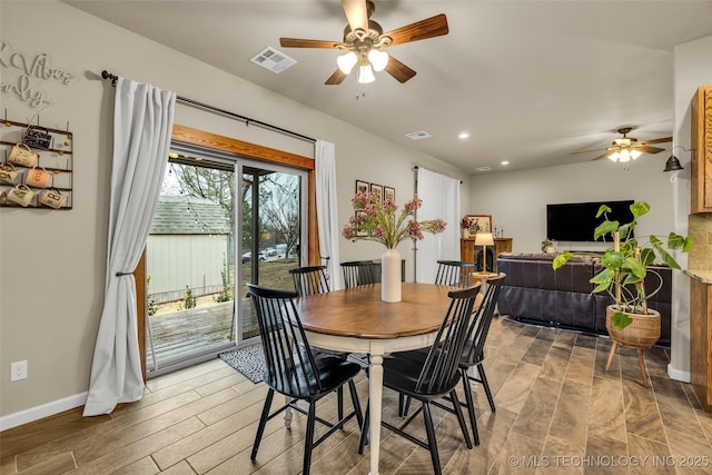 dining space with hardwood / wood-style floors and ceiling fan